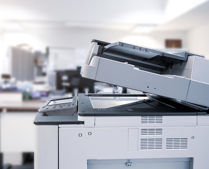 Side view of a large white copier in office