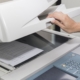 Close up of hand closing copier machine to scan a document
