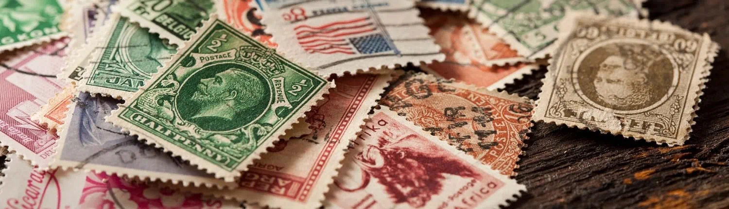 A scatter of colorful used postage stamps