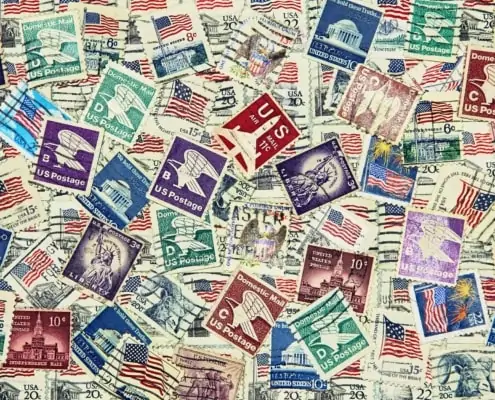Set of various USA postage stamps as background