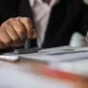 Image of a business person stamping a document.
