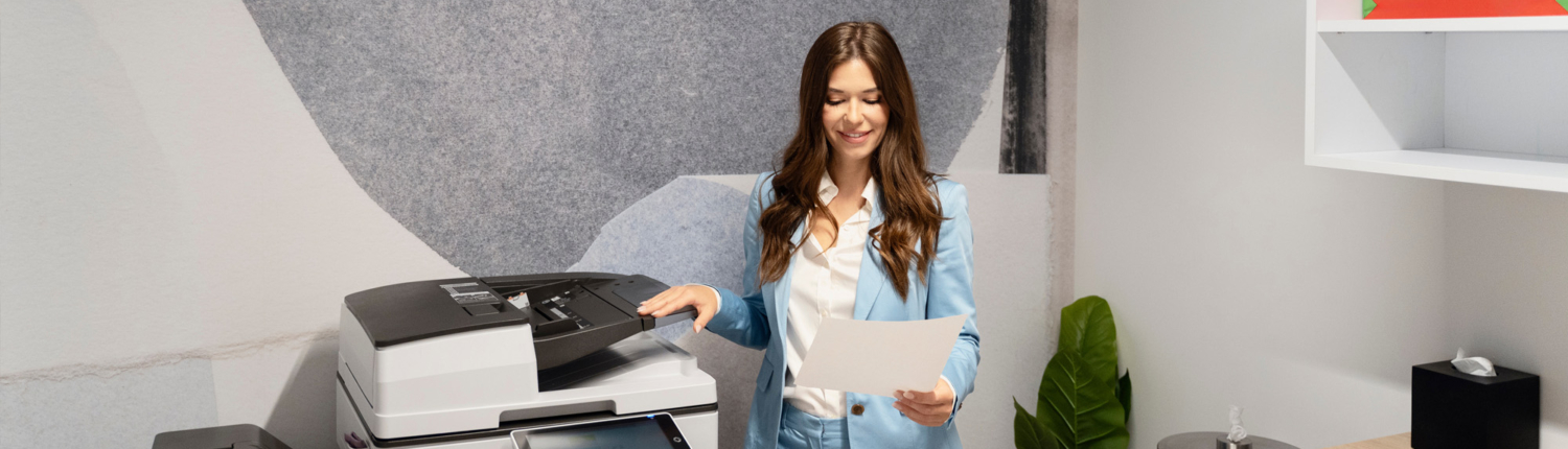 woman standing near an office printer