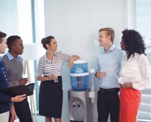 Employees standing near the office water tank