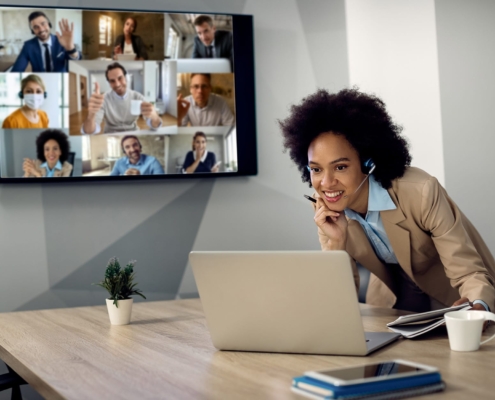 Image of a woman hosting a remote meeting on her laptop