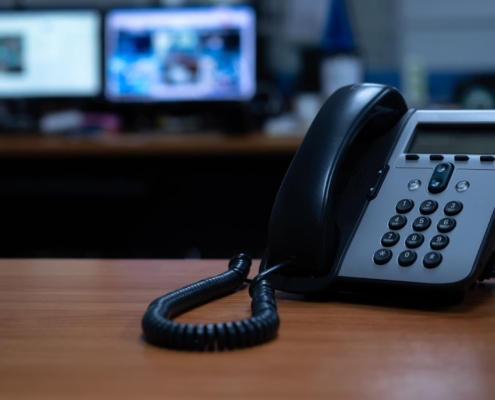 IP telephone device on wooden table in office room