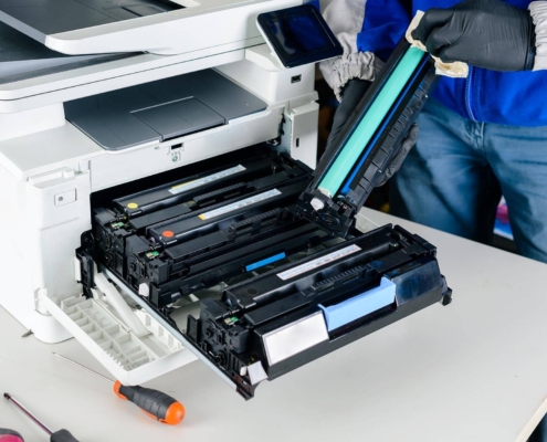 Close up of service technician repairing laser printer