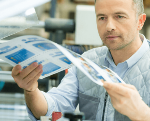 manager examining proofs from print production