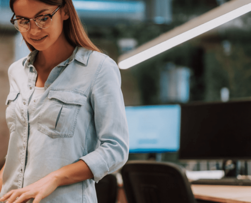 Woman smiling down at the office printer