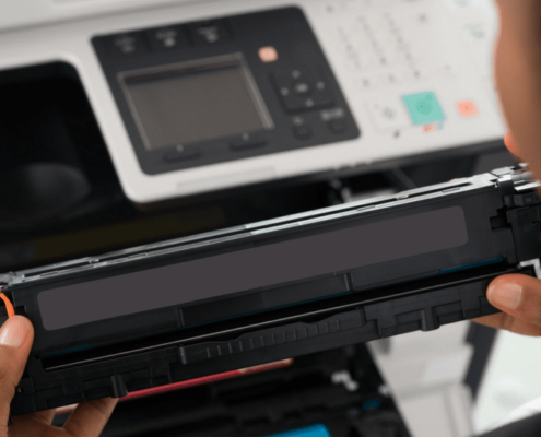 Close up shot of hands replacing a printer component