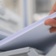 Close up of hand taking paper from printing tray