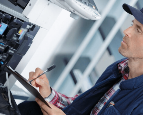 Technician performing Canon copier repair