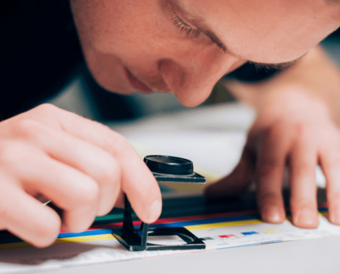 Close up of man inspecting print