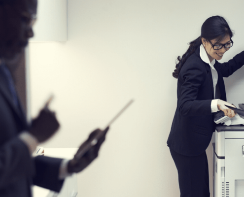 Image of three lawyers in office printing room