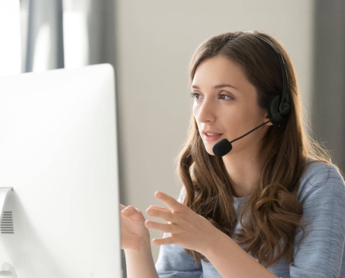 Side view of someone using a headset while on a call