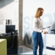 woman in blue jeans using office printer