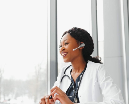 Doctor working at her office online using portable information device