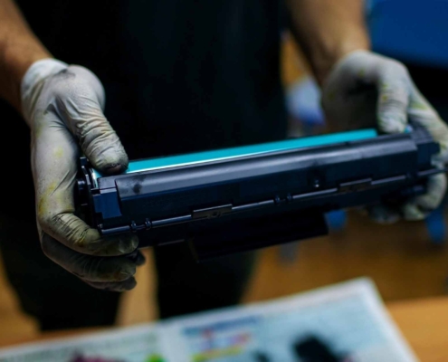 Person holding toner for a printer