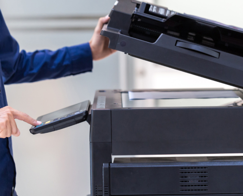 Businessman press button on panel of printer photocopier network