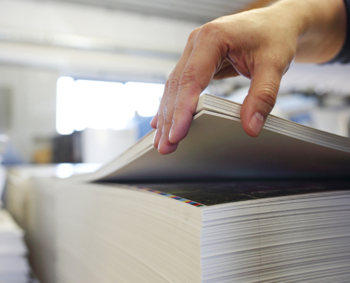 Printing house. The employee checks the paper's weight