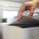 Printing house. The employee checks the paper's weight