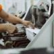 Close up shot of worker's hand preparing carton for printing in a modern printing house