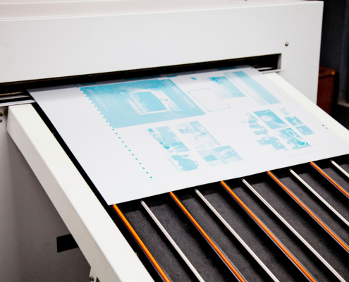 Paper being printed from printer, side view