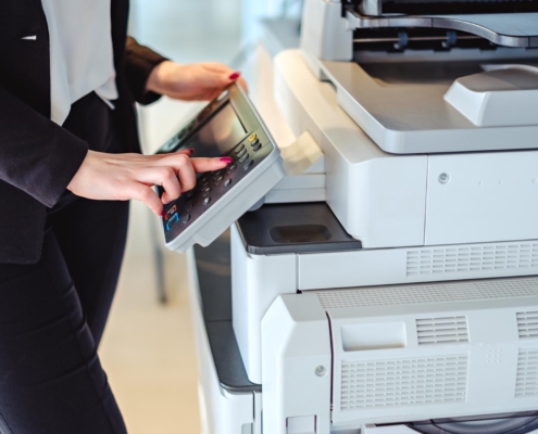 Worker using printer in office