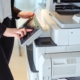 Worker using printer in office